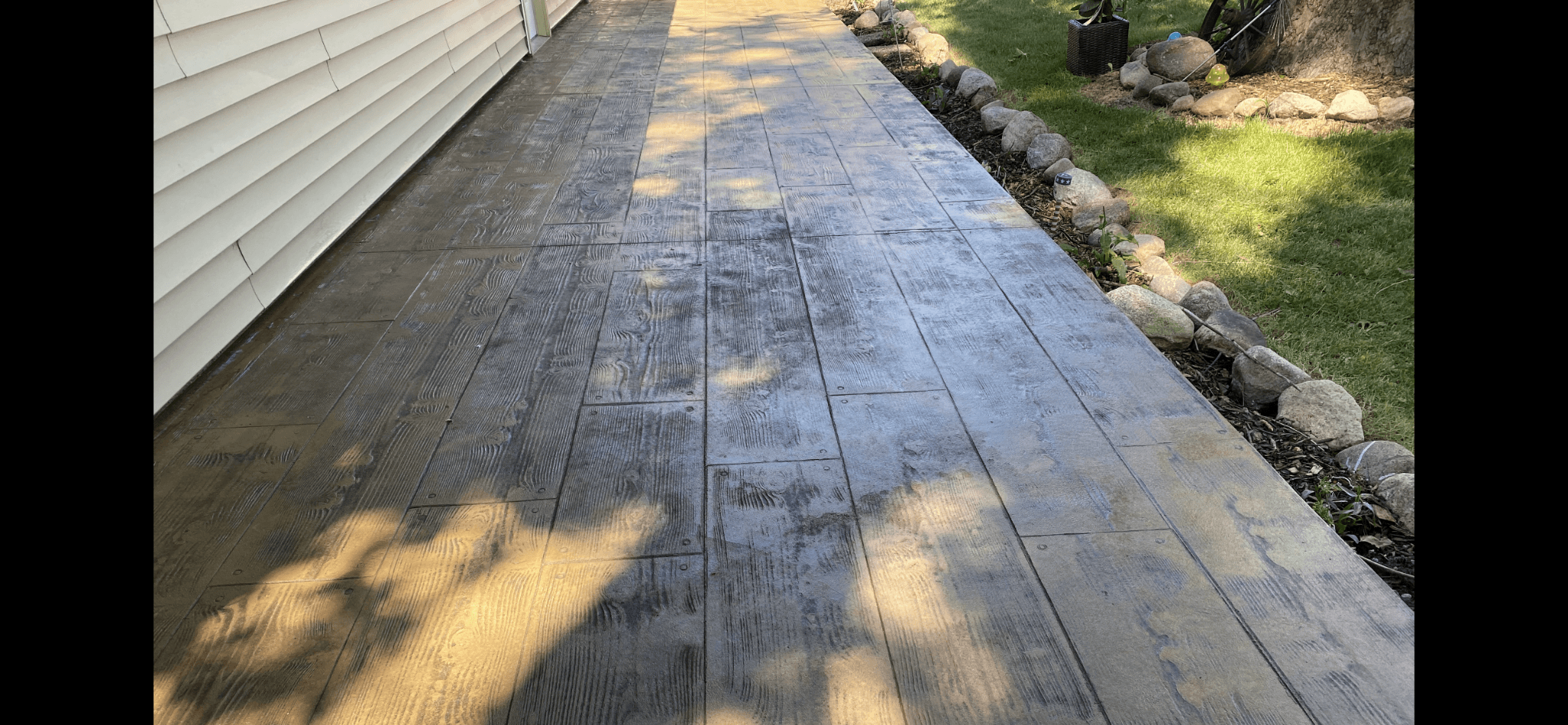 Stamped concrete walkway with wood plank pattern by S&T Concrete
